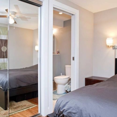 Bedroom includes queen size bed, dresser, night tables, and closet.